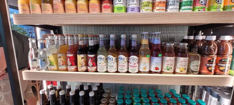 Imported Italian sodas, organic beverages and functional teas on a curated premium drinks bay.